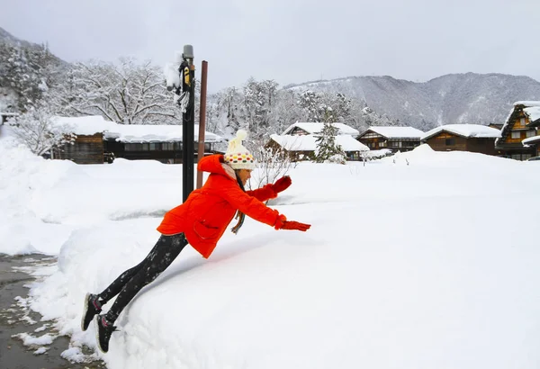 woman lay down on the snow and enjoy snow in the winter