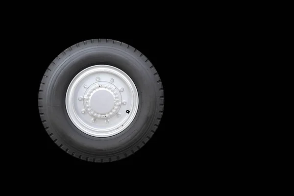 Big truck tire isolated on background.