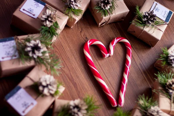 Decorated gift boxes and candies on the wooden background — Stock Photo, Image