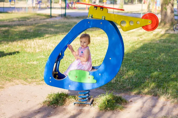 Little girl playing in toy plane in a playground — Stock Photo, Image