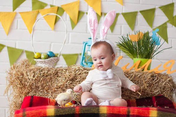 Cute little baby wearing bunny ears on Easter day
