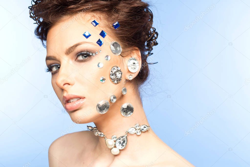 portrait of beautiful girl with diamonds on her face