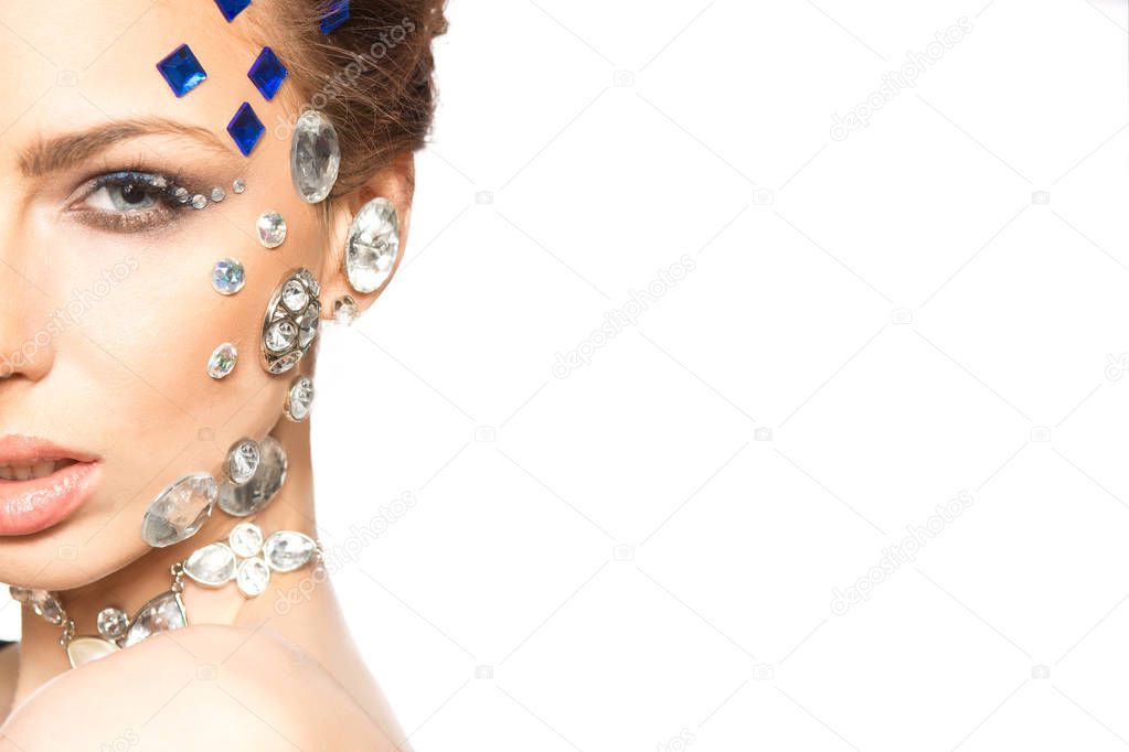 portrait of beautiful girl with diamonds on her face