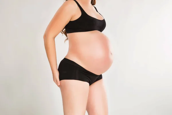 Gravid kvinna i svart underware studio skott — Stockfoto