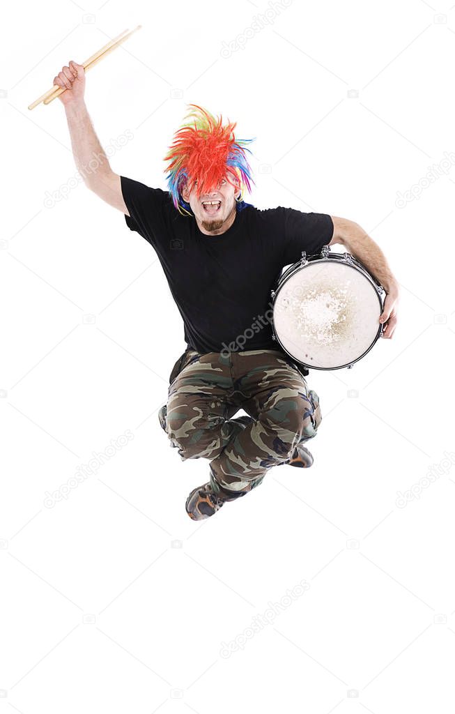 Young guy jumping with drum