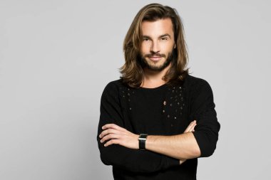 çapraz kol ve satisfa ile kameraya bakarak gündelik genç adam