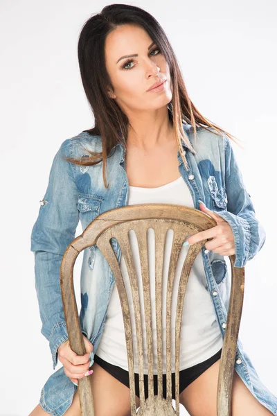 Young model sitting on the old chair. — Stock Photo, Image