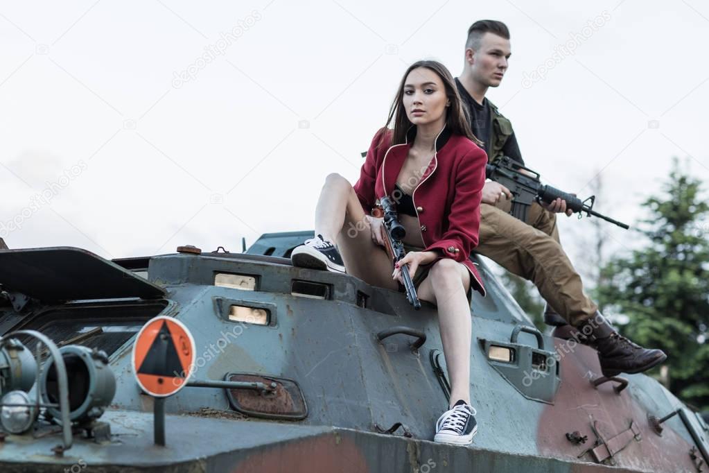 Couple of soldiers sitting on the tank.