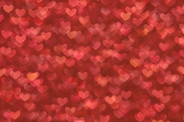 Defocused abstrakt röda hjärtan ljus bakgrund — Stockfoto