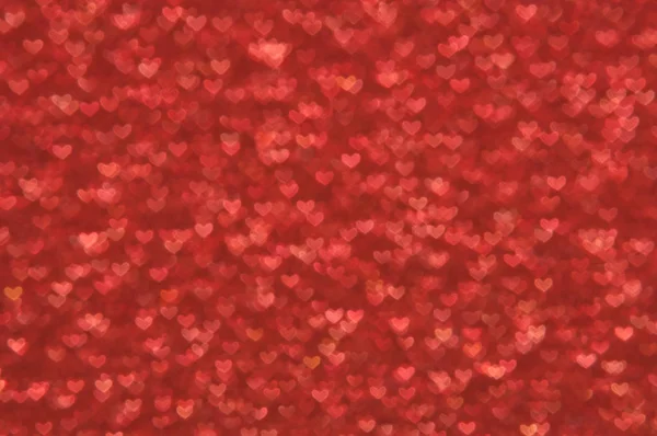 Defocused abstrakt röda hjärtan ljus bakgrund — Stockfoto