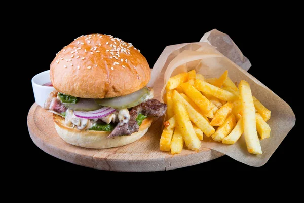 Burger with french fries isolated on a black background — Stock Photo, Image