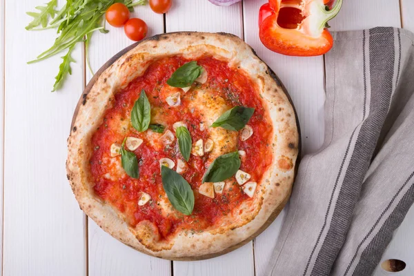 Whole pizza on wooden board — Stock Photo, Image