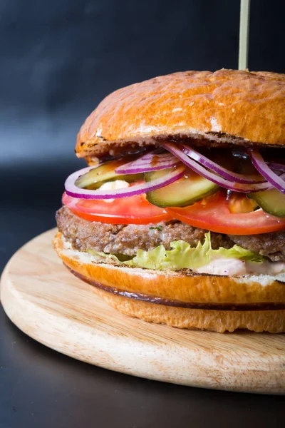 Beef burger on wooden board — Stock Photo, Image