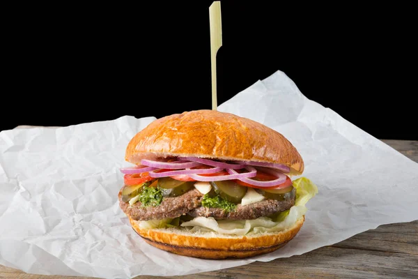 Huge burger on a wrapping paper — Stock Photo, Image