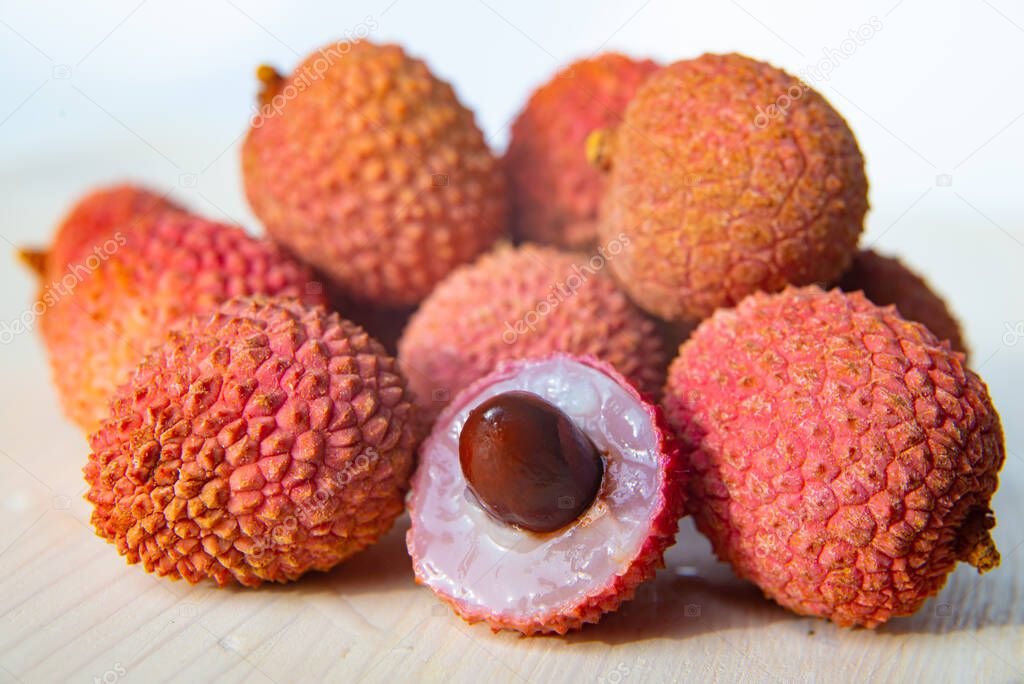 Ripe, fresh lychees on a wooden table
