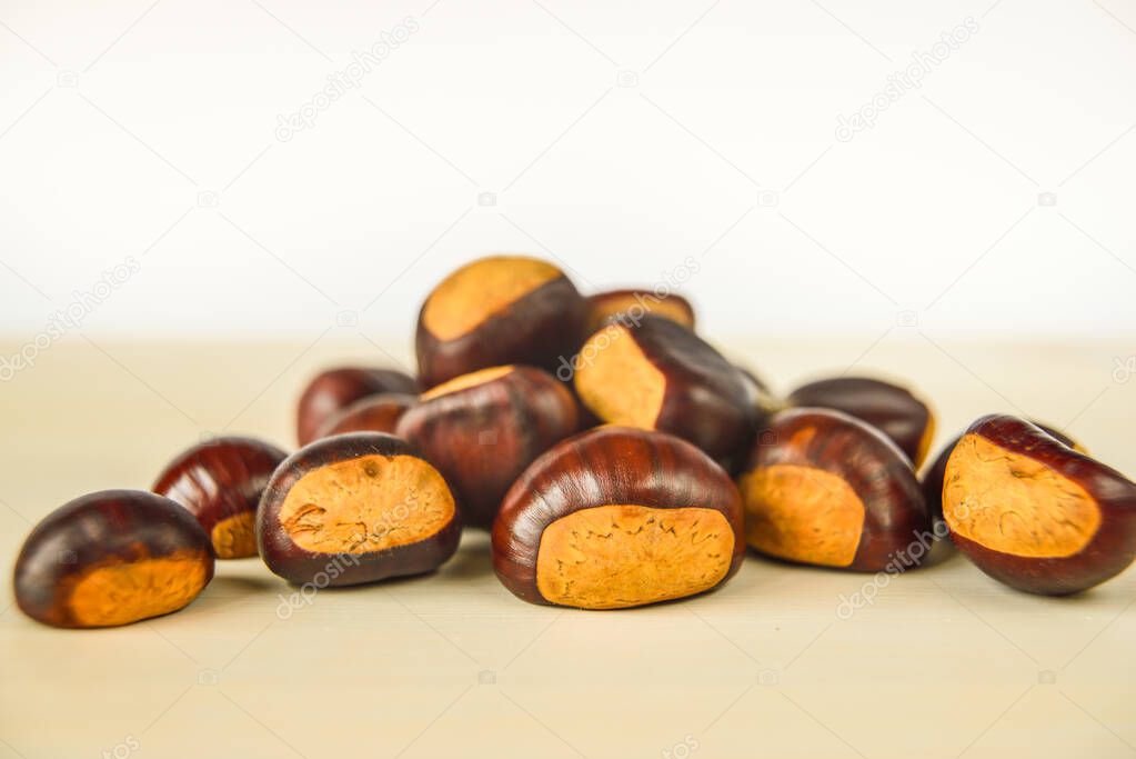 Freshly picked chestnuts, on a wooden surface