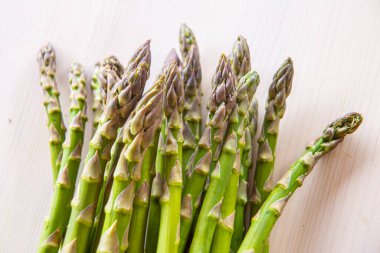 Ahşap yüzeyde yeni toplanmış kuşkonmaz.