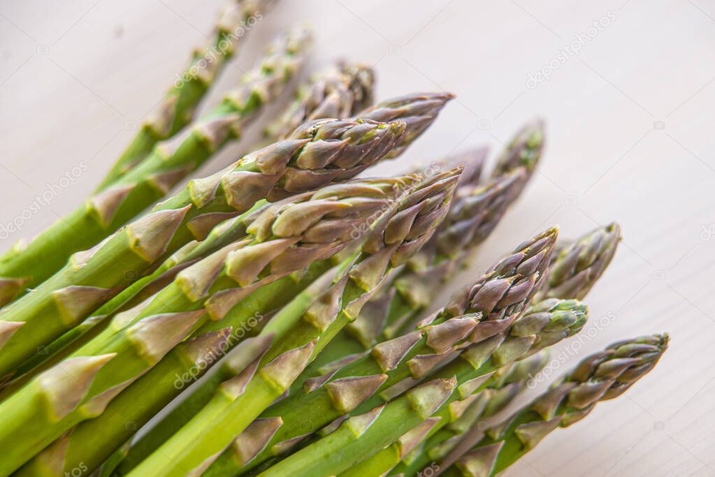 Freshly picked asparagus, on wooden surface