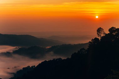 Gün doğumunda dağ sisi, gün doğumunda sis, gün doğumunda dağın tepesinde sis. Gün doğumunda dağlarda güzel bir manzara..