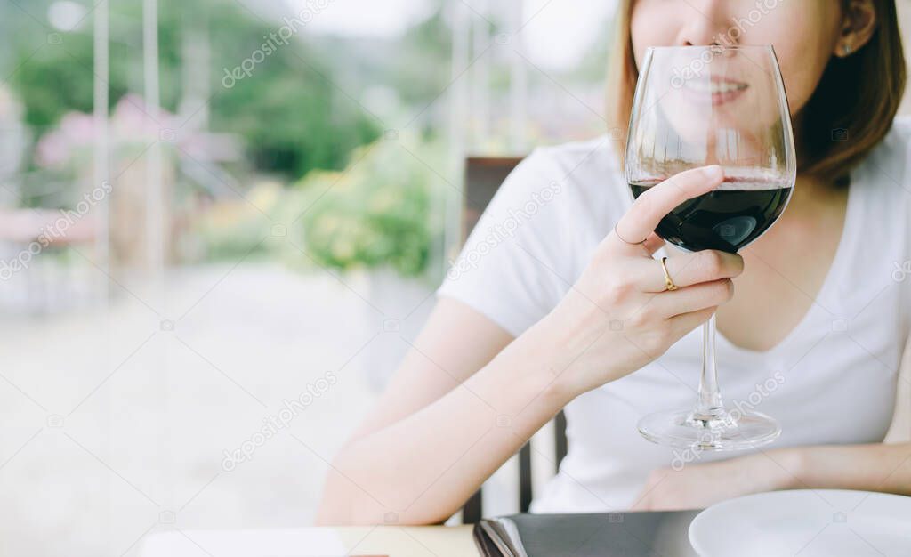 wine tasting tourist woman.Young Woman drinking wine in  Italian style restaurant