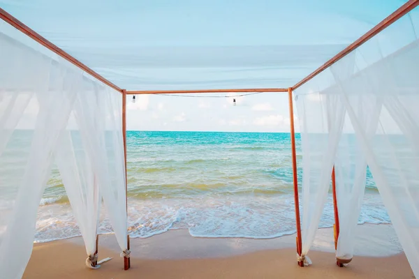 Wind blow white curtains on sand sea,summer holiday concept.