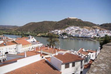 the town Alcoutim in Portugal and the town Sanlucar de Guadiana in Spain clipart