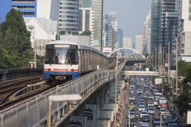 a bts skytrain over the trafic at the Sathon road in the city centre at Sathon in the city of Bangkok in Thailand. Thailand, Bangkok, November, 2017. clipart
