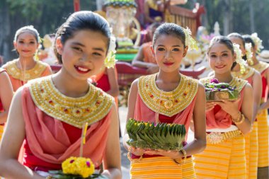 traditional dresst thai people at the Loy Krathong Festival in the Historical Park in Sukhothai in the Provinz Sukhothai in Thailand.   Thailand, Sukhothai, November, 2019 clipart