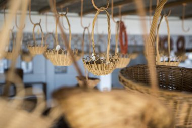 Portekiz 'in Madeira Adası' ndaki Madeira Adası 'nın doğusundaki Camacha kasabasındaki Arema Kafe Relogio Reklam Dükkanı' nda sepet dokuma işi. Portekiz, Madeira, Nisan 2018