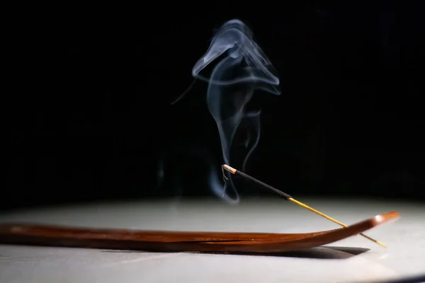 Lit Stick Incense Smoke Wooden Base White Table Black Background — Stock Photo, Image