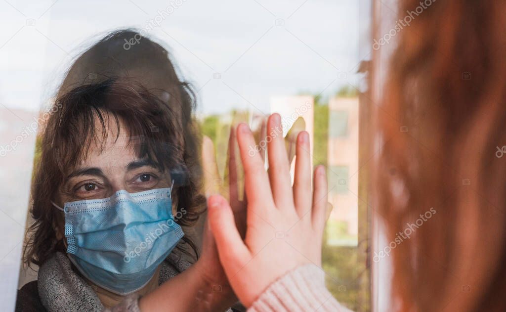 Mother and daughter are separated because of the quarantine Corona Virus Covid-19, social distancing. Coronavirus. Covid-19. Pandemic. Coronavirus devices