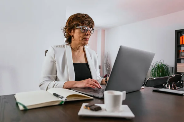Business woman working from home. Senior woman working from home. Female entrepreneur works from home. Businesswoman working with her laptop from home.Female manager working from home for quarantine.