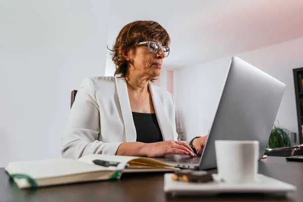 Business woman working from home. Senior woman working from home. Female entrepreneur works from home. Businesswoman working with her laptop from home.Female manager working from home for quarantine.