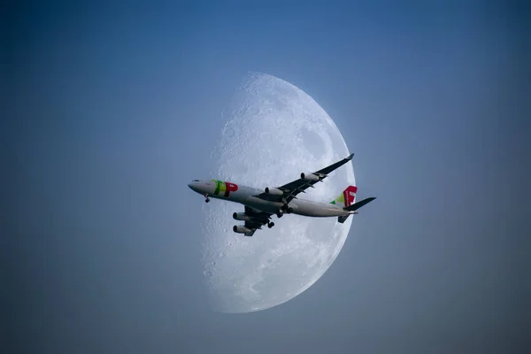 Huge Moon in the sky and airplane