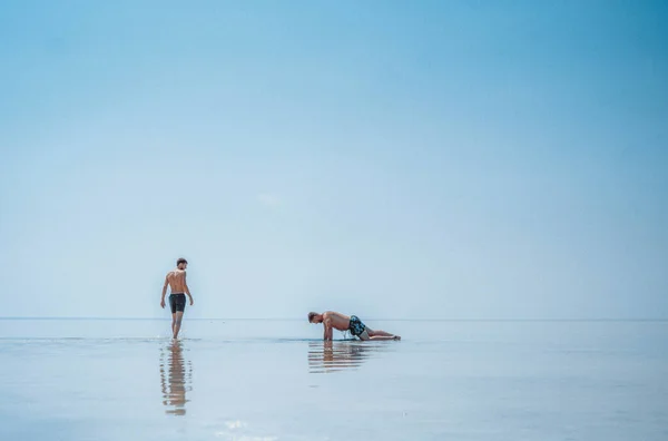 men swim in a salt lake