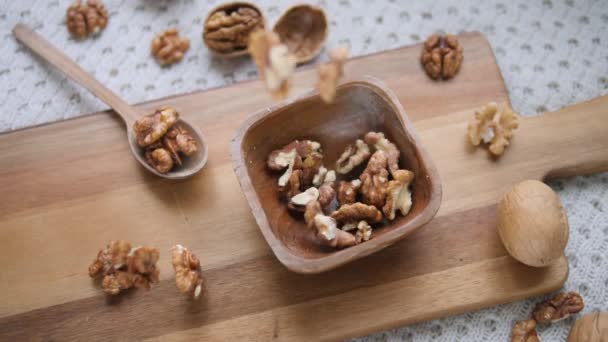 Cibo sano. Noci in ciotola di legno su tavola di legno. Vista dall'alto . — Video Stock