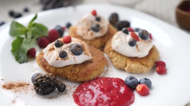 Panqueques de tofu, Syrniki vegano o buñuelos de cuajada con bayas frescas y canela . — Vídeo de stock