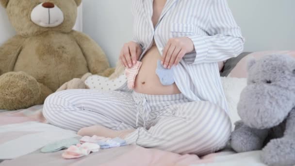 Belly Of Pregnant Woman With Baby Socks
