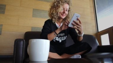 Young Woman Use Mobile Phone in Coffee Shop