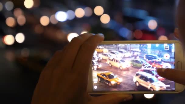 Händerna ta en bild med mobiltelefon av Night Street Road med trafik — Stockvideo