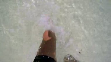 Deniz suyunda yalınayak koşan adam