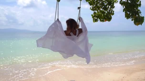 Happy Senior Woman on Swings at Beach — Stock video