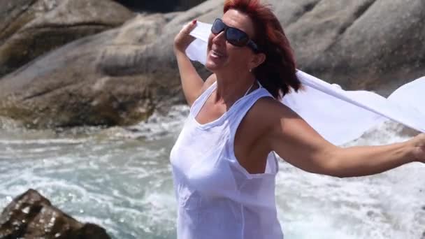 Donna anziana con le braccia distese sulla spiaggia — Video Stock