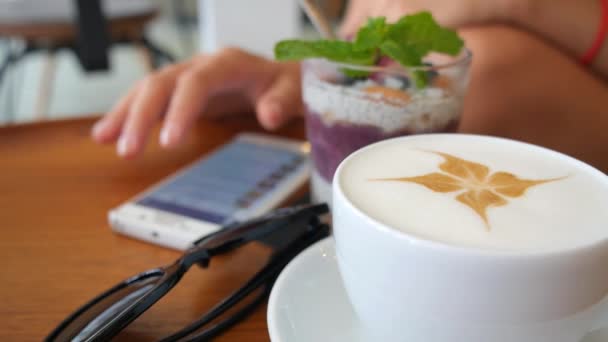 Usando telefone inteligente na cafetaria — Vídeo de Stock