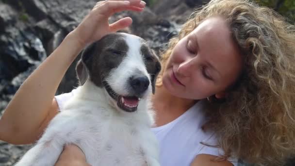 Junge Frau mit süßem Hund am Wasserfall — Stockvideo