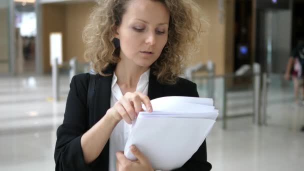 Femme d'affaires avec des papiers dans un immeuble de bureaux — Video