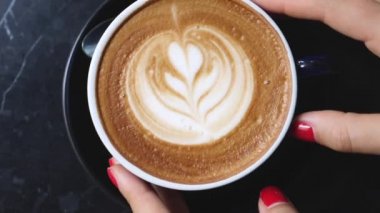Closeup Of Woman Hands With Coffee Cup In Cafe