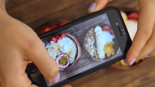 Female Hands Taking Photo of Healthy Smoothie Bowl Breakfast with Smartphone — стоковое видео