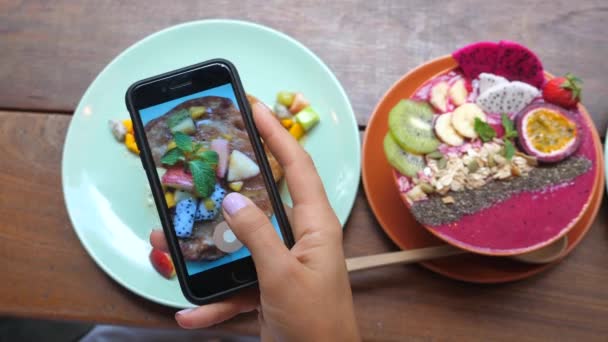 Blogger de alimentos tomando fotos de comida vegana para el desayuno con Smartphone . — Vídeos de Stock