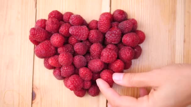 Female Hand Making Heart Of Raspberry — Stock Video